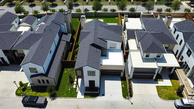 an aerial view of houses with outdoor space