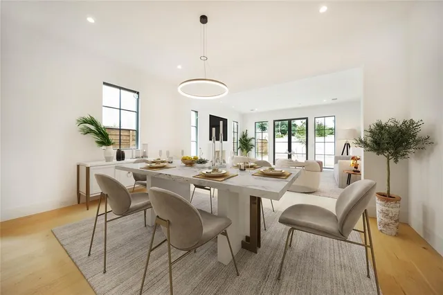 a view of a dining room with furniture and a potted plant