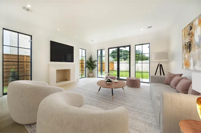 a living room with fireplace furniture and a flat screen tv