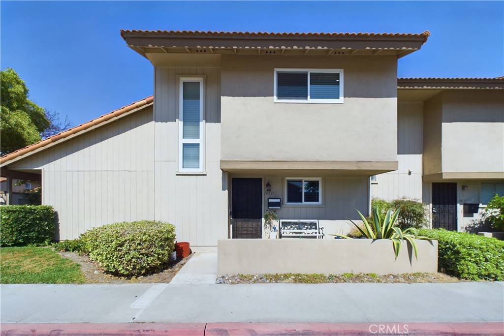 a white house with a large pool and yard