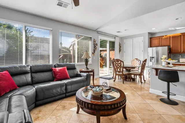 a living room with furniture a large window and a table