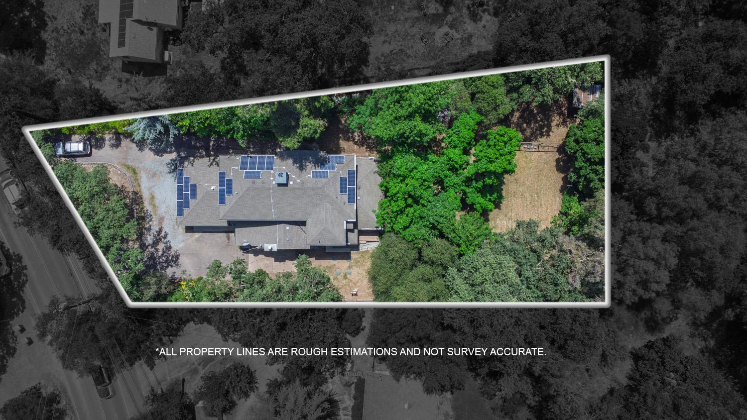 6332 Horseshoe Bar Road Loomis, CA 95650 - Photo 82 of 85 Aerial property view featuring a gabled roof, numerous solar panels, a gravel driveway, and surrounding mature foliage