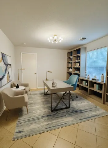 a living room with furniture a pool table and a couch