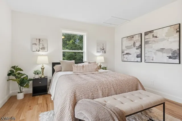 a bedroom with a bed and a potted plant