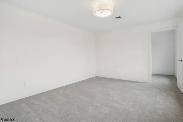 a bedroom with a large bed and wooden floor