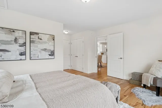 a bedroom with a bed and large windows