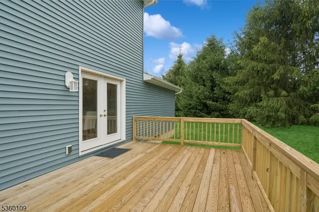 a view of a balcony with wooden floor and fence