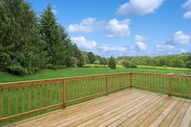 a view of a wooden deck with a yard