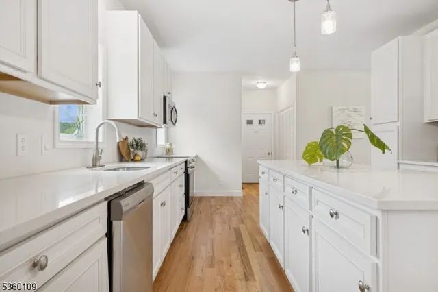 a large kitchen with a sink and cabinets