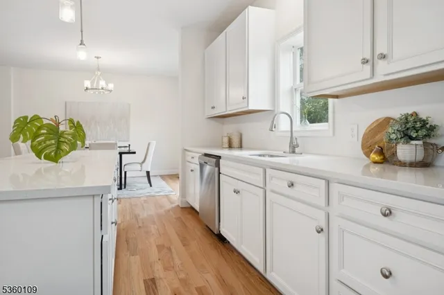 a kitchen with a sink a window and cabinets