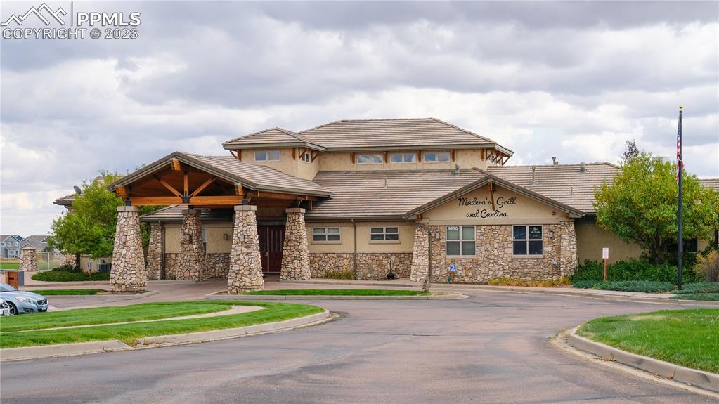 10751 Rolling Mesa Drive Peyton, CO 80831 - Photo 13 of 27 a front view of a house with a garden