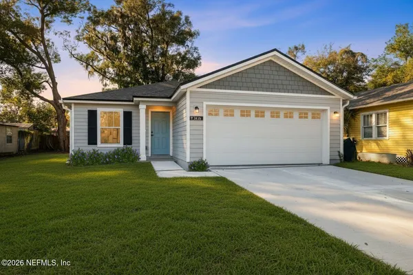 a front view of a house with a yard and garage