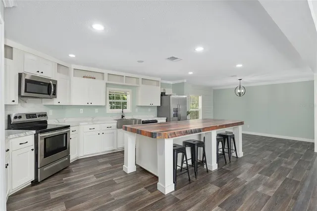a kitchen with a stove a sink and a refrigerator