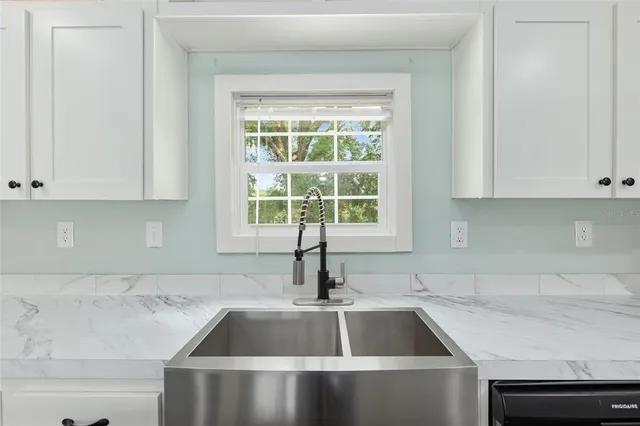 a kitchen with a sink and cabinets
