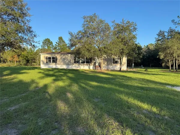 a view of a house with a big yard