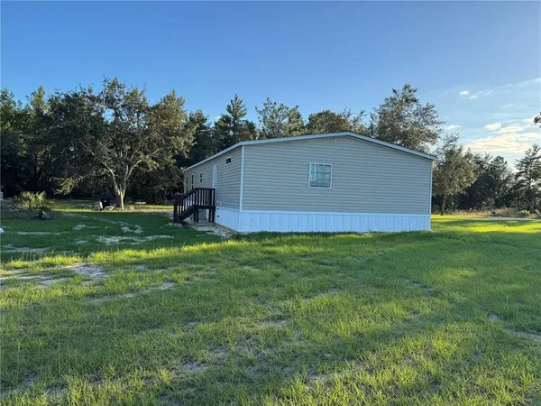 a aerial view of a house with a yard and sitting area