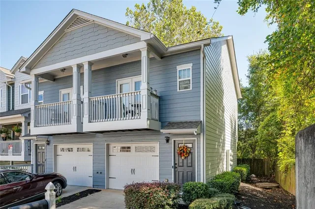 a front view of a house with a tree