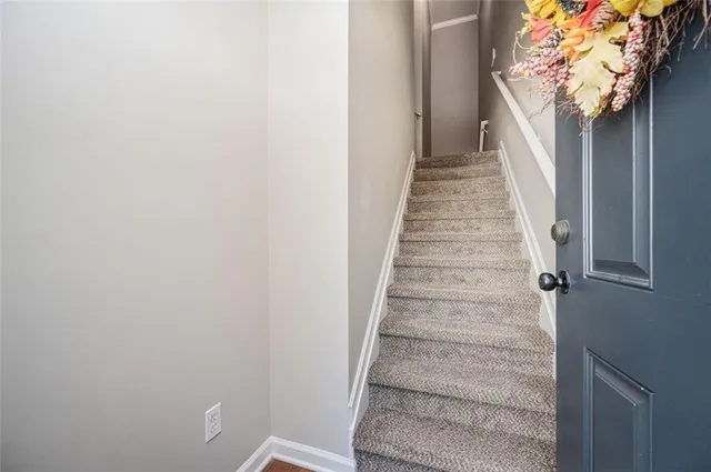 a view of staircase with white walls and windows