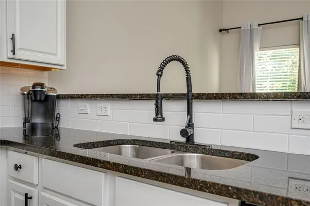 a stove top oven sitting inside of a kitchen