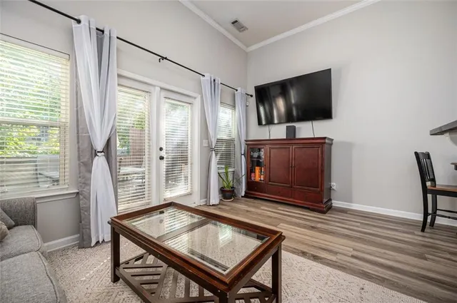 a living room with furniture and a wooden floor