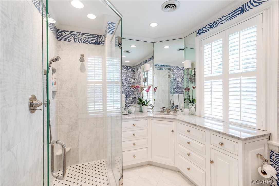 14 Roslyn Road Richmond, VA 23226 - Photo 30 of 49 a bathroom with a double vanity sink a large mirror a shower and a bathtub