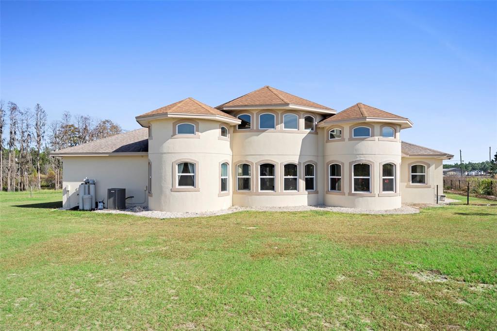 13023 Sweet Hill Road Polk City, FL 33868 - Photo 13 of 49 a front view of a house with a garden