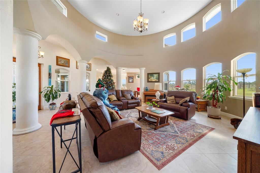 13023 Sweet Hill Road Polk City, FL 33868 - Photo 15 of 49 a living room with furniture or chandelier and a rug