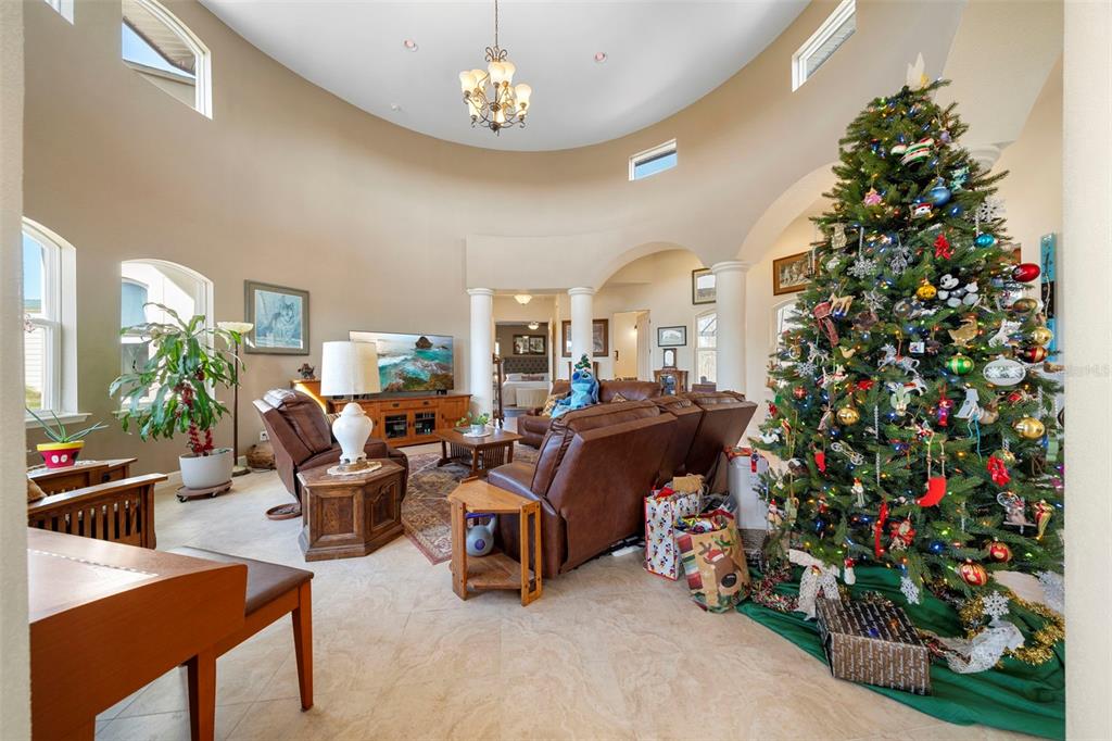 13023 Sweet Hill Road Polk City, FL 33868 - Photo 16 of 49 a living room with furniture and a chandelier