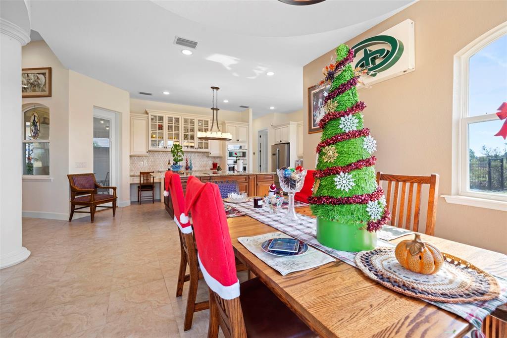 13023 Sweet Hill Road Polk City, FL 33868 - Photo 21 of 49 a dining room with furniture and a floor to ceiling window