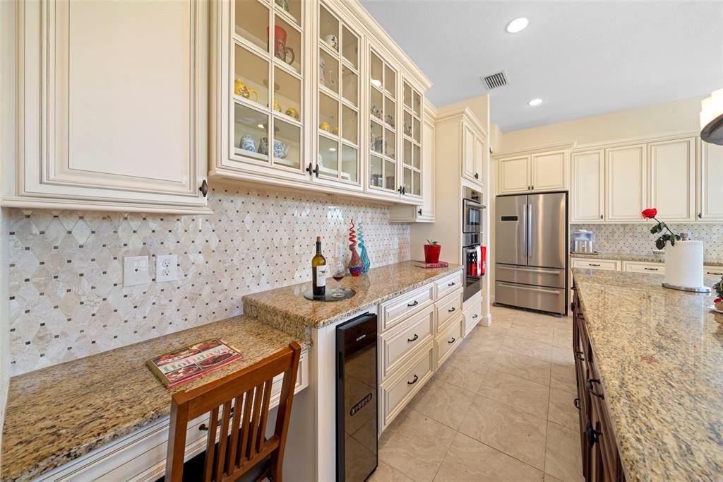 13023 Sweet Hill Road Polk City, FL 33868 - Photo 23 of 49 a kitchen with stainless steel appliances granite countertop a stove and a sink