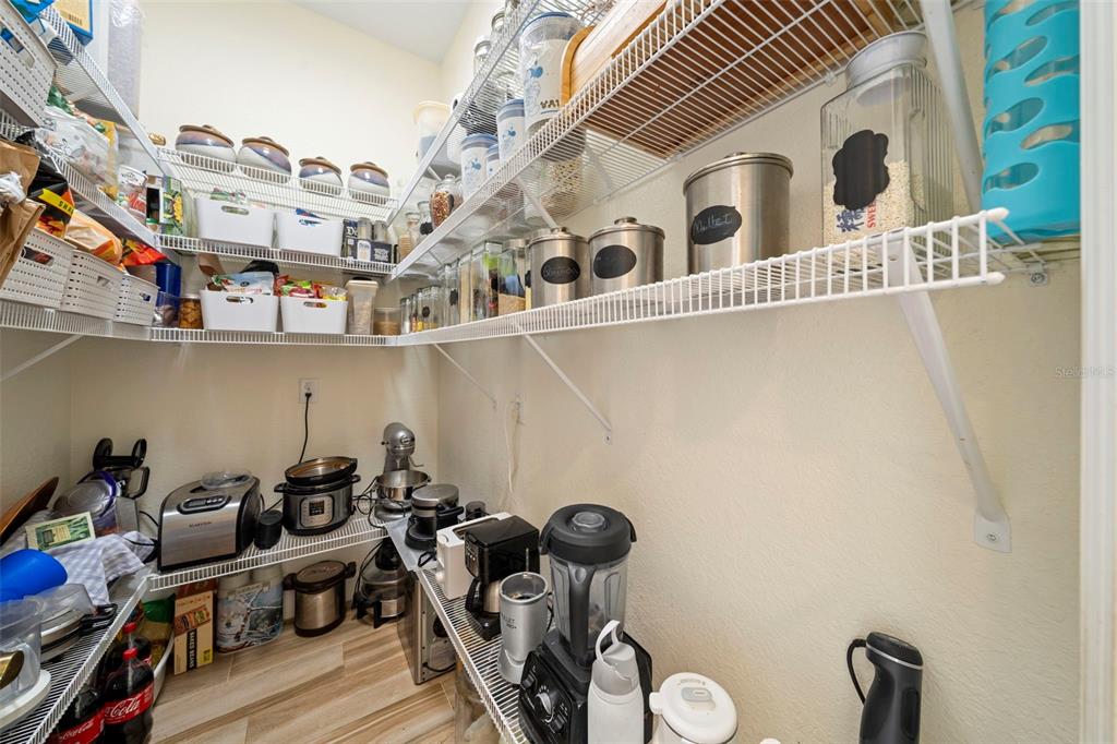 13023 Sweet Hill Road Polk City, FL 33868 - Photo 25 of 49 a close up of a storage and utility room with racks on the wall