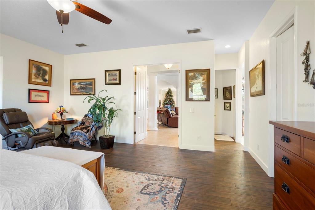 13023 Sweet Hill Road Polk City, FL 33868 - Photo 28 of 49 a bedroom with furniture and a wooden floor