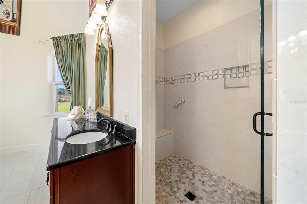 13023 Sweet Hill Road Polk City, FL 33868 - Photo 32 of 49 a bathroom with a sink and a mirror