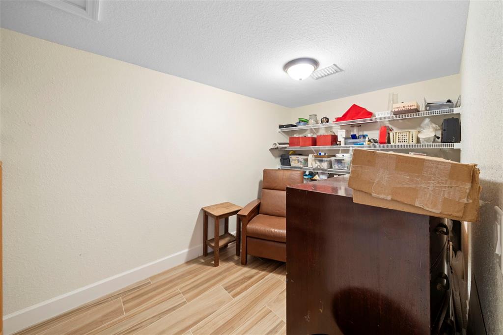 13023 Sweet Hill Road Polk City, FL 33868 - Photo 35 of 49 a workspace room with furniture and wooden floor