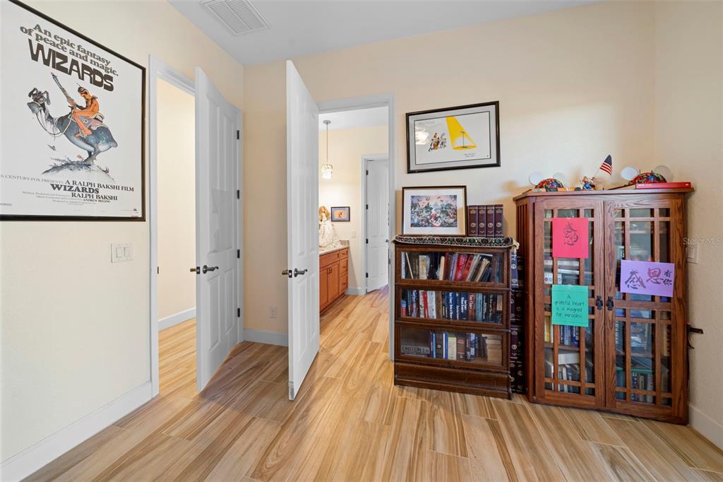 13023 Sweet Hill Road Polk City, FL 33868 - Photo 37 of 49 a view of a hallway with wooden floor and entryway
