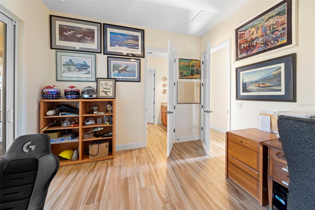 13023 Sweet Hill Road Polk City, FL 33868 - Photo 39 of 49 a view of a workspace with furniture and wooden floor