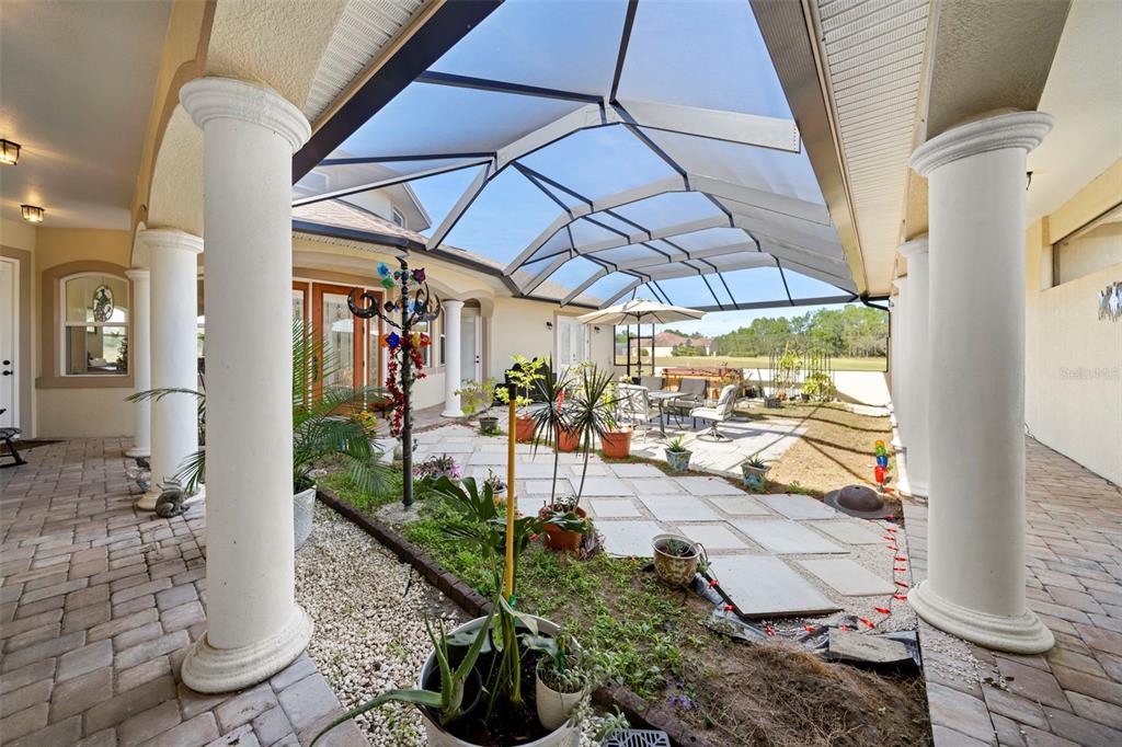 13023 Sweet Hill Road Polk City, FL 33868 - Photo 40 of 49 a view of a patio with table and chairs potted plants