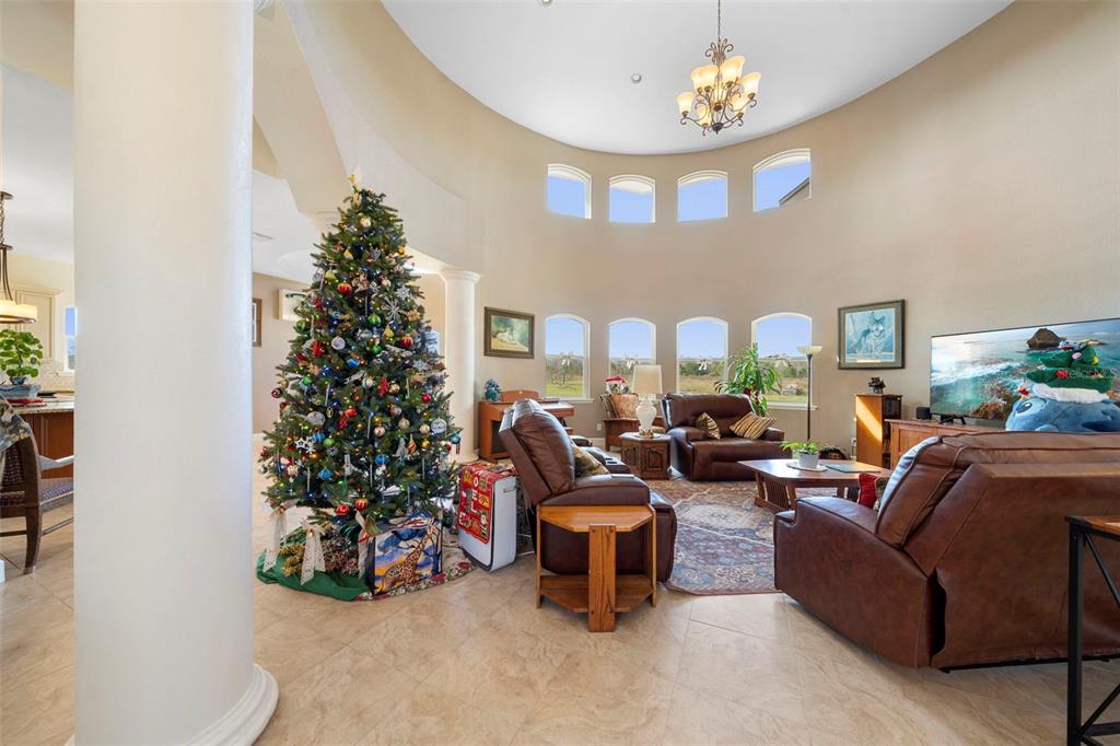 13023 Sweet Hill Road Polk City, FL 33868 - Photo 48 of 49 a living room with furniture potted plant and a chandelier