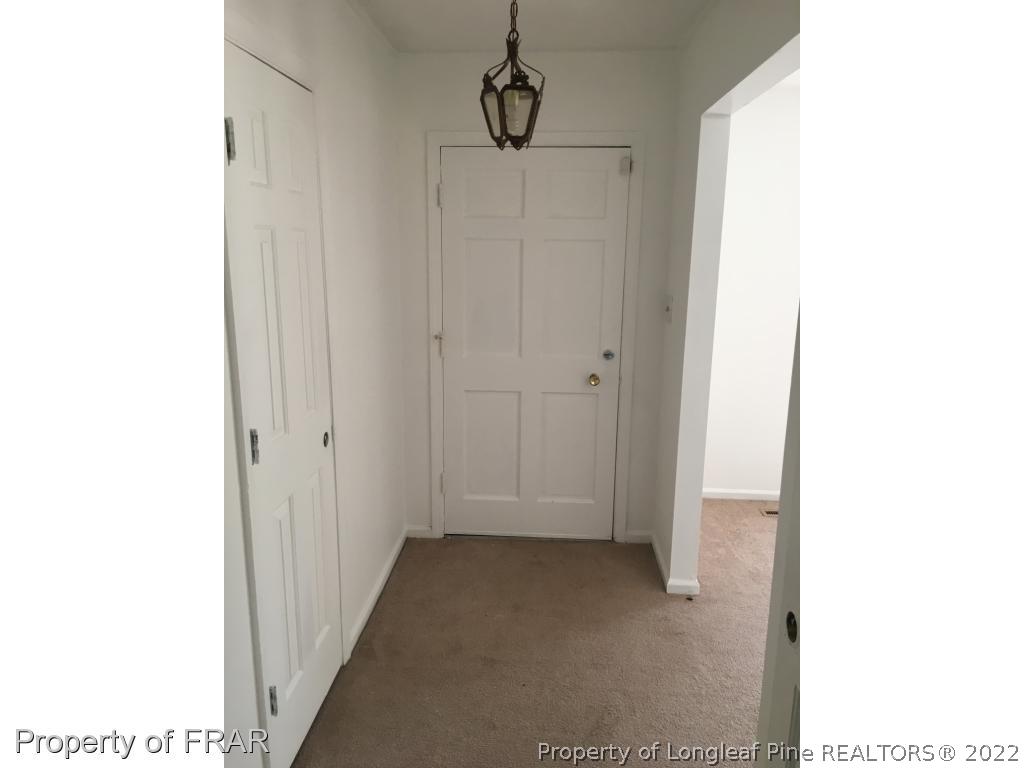 322 Old Farm Road Raeford, NC 28376 - Photo 3 of 11 a view of a hallway with wooden floor