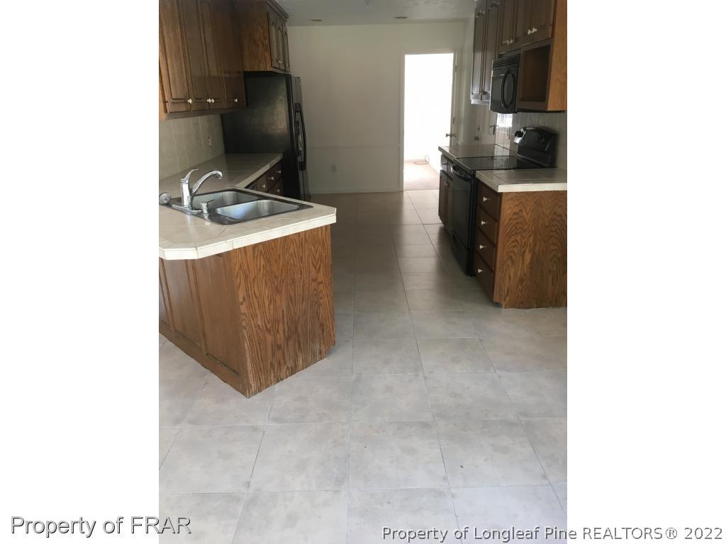 322 Old Farm Road Raeford, NC 28376 - Photo 5 of 11 a kitchen with a sink and cabinets