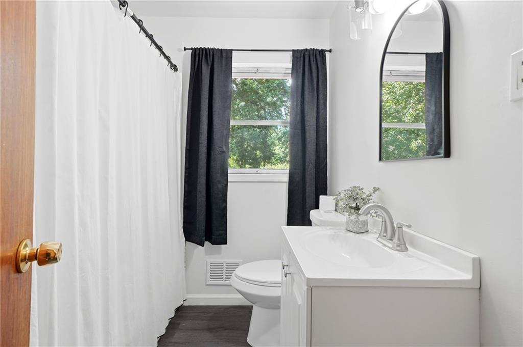 430 Church Road Southwest Marietta, GA 30060 - Photo 17 of 35 a bathroom with a sink toilet and a mirror