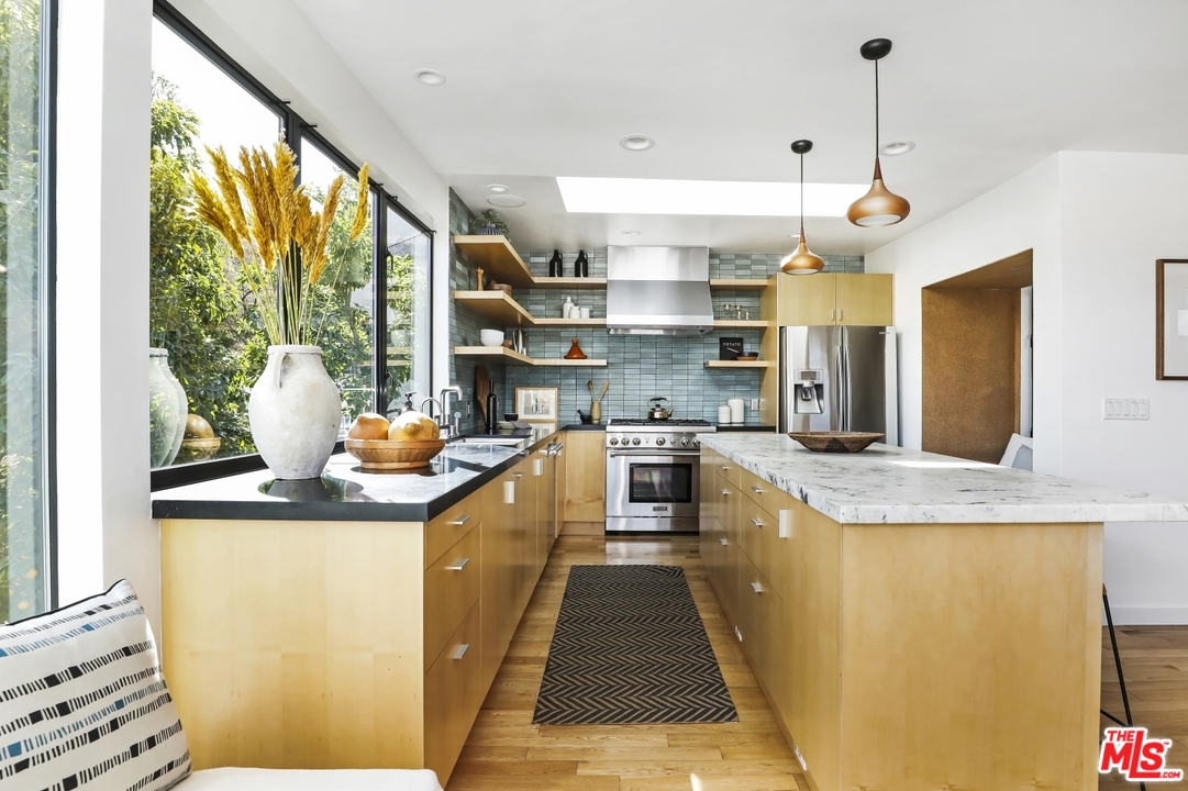 1508 Elevado Street Los Angeles, CA 90026 - Photo 14 of 38 a kitchen with stainless steel appliances granite countertop a sink a stove and a wooden floors