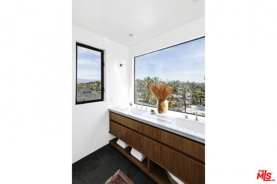 1508 Elevado Street Los Angeles, CA 90026 - Photo 21 of 38 a bathroom with a sink and a mirror