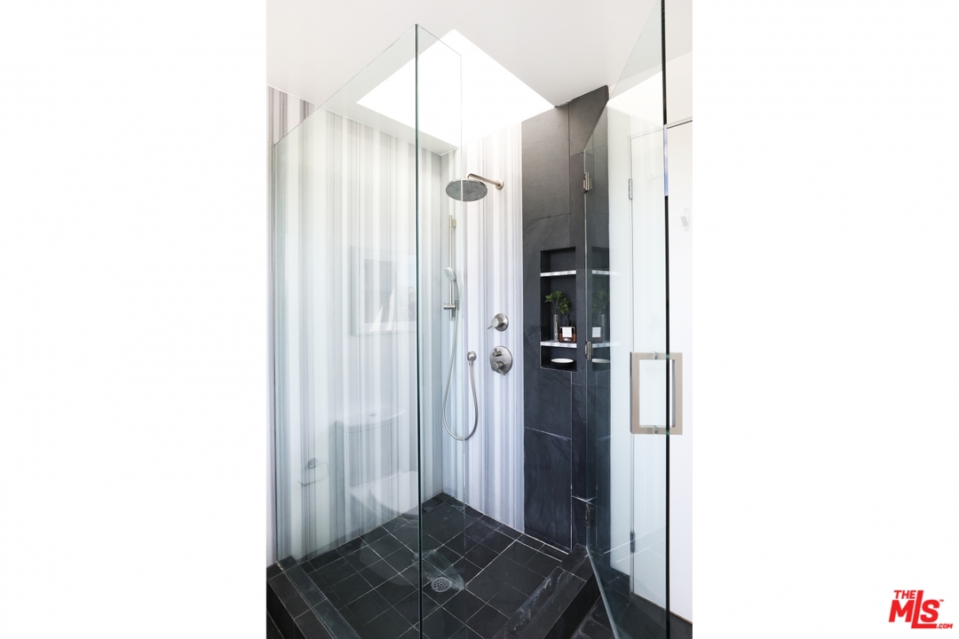 1508 Elevado Street Los Angeles, CA 90026 - Photo 22 of 38 a bathroom with a sink and a mirror