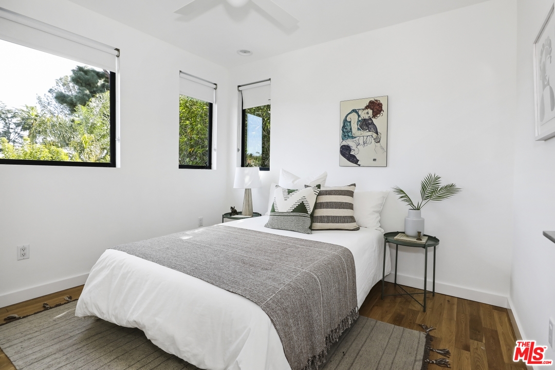 1508 Elevado Street Los Angeles, CA 90026 - Photo 23 of 38 a bedroom with a bed and a painting on the wall