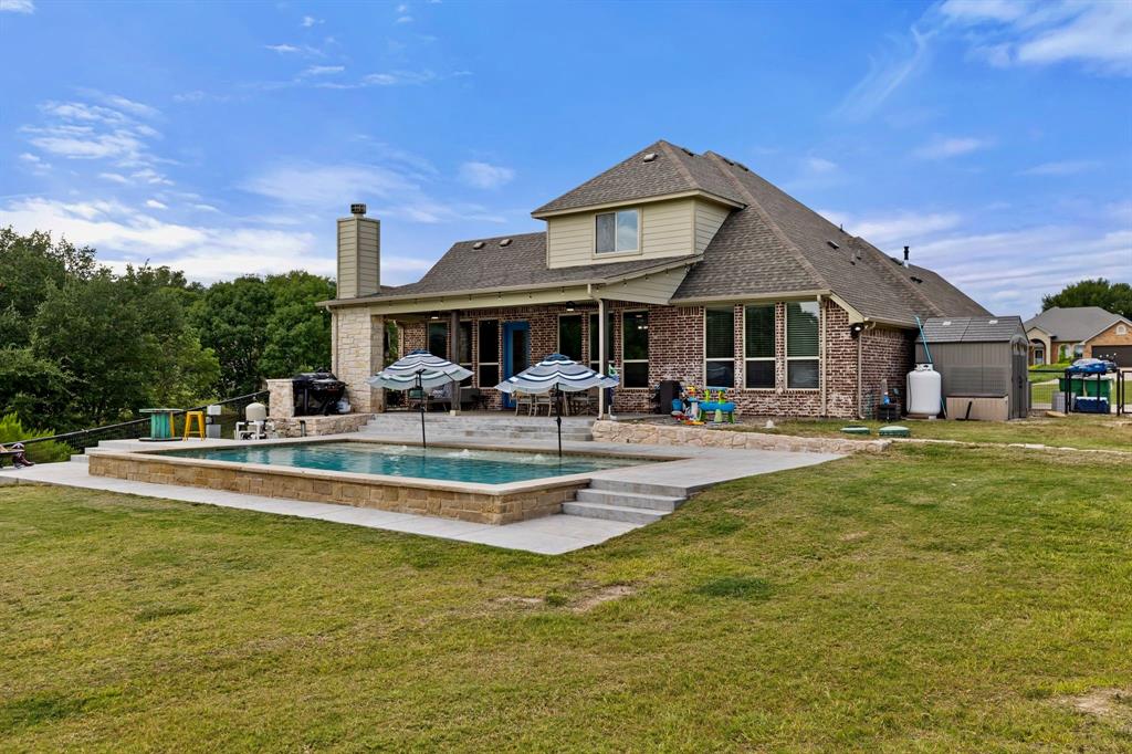 2103 Cash Point Court Granbury, TX 76049 - Photo 35 of 38 a view of a house with a swimming pool