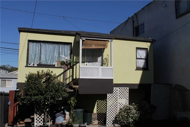 a front view of a house with wooden fence