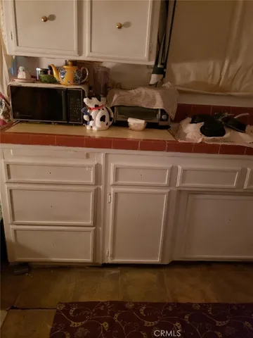 a kitchen with sink a stove and cabinets