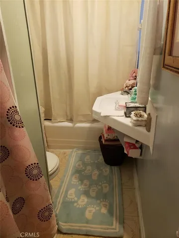 a bed sitting in a room next to a window