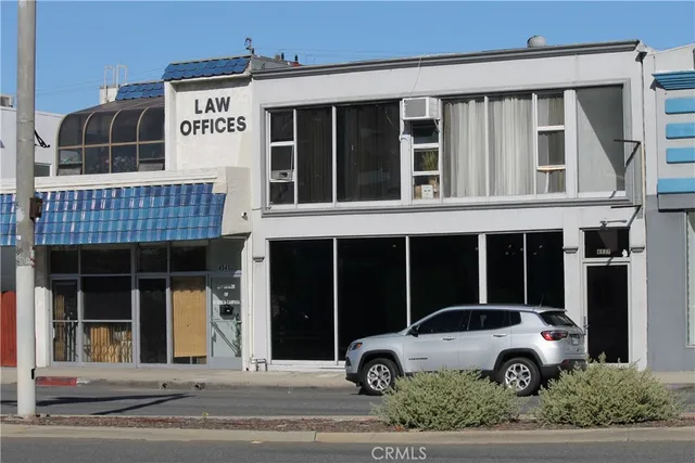 a view of a car parked front of a building